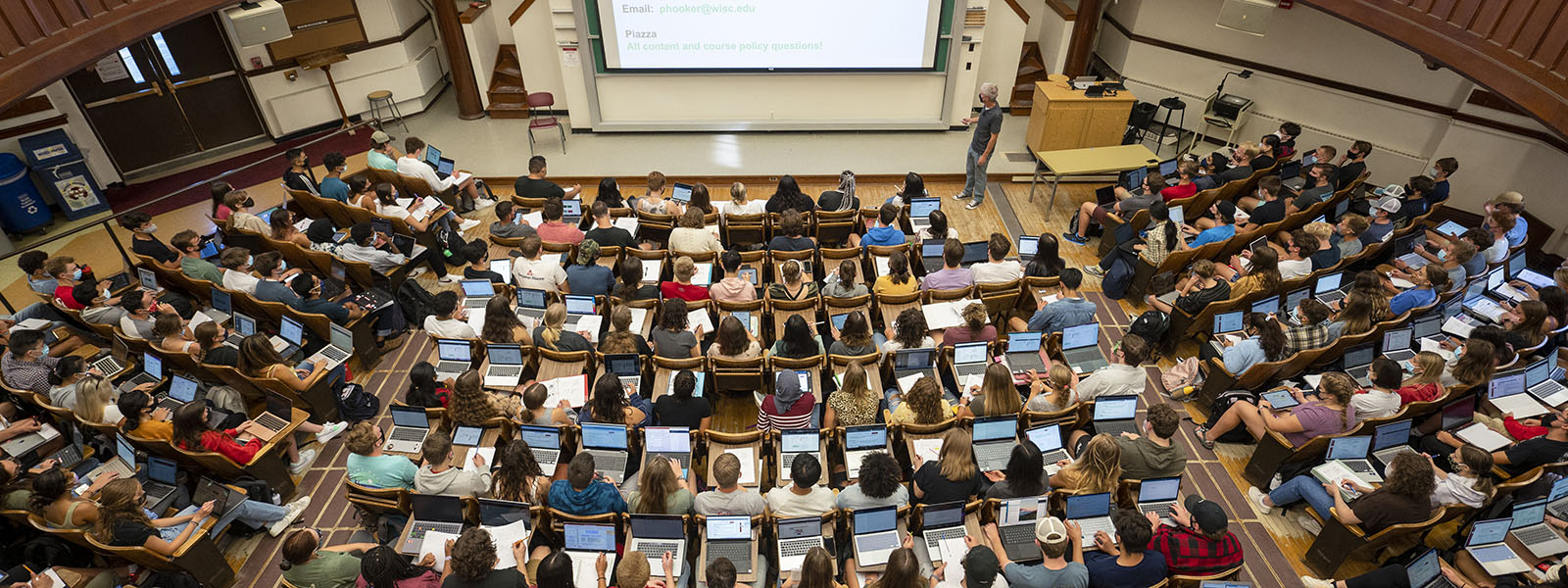 Over head view of a lage classroom filled with students. 